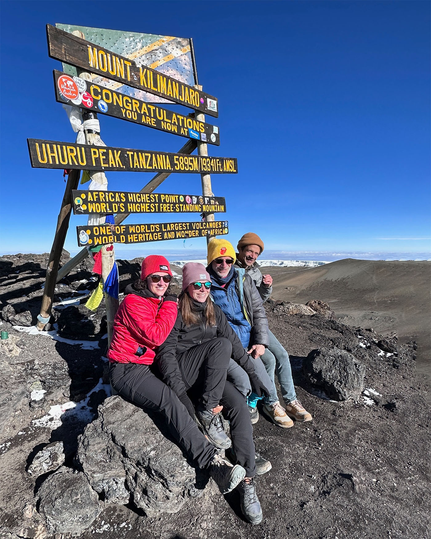 Irva and his children summiting Kilimanjaro