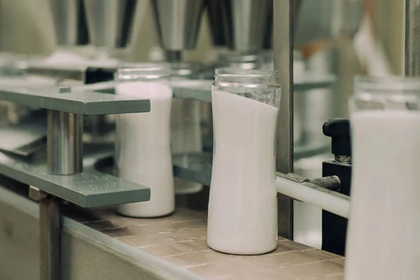 Filling containers with salt on a manufacturing line