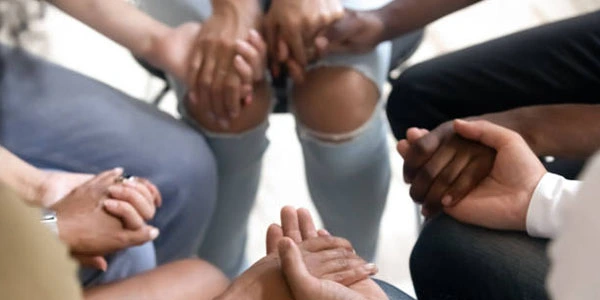 group holding hands and praying