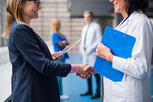 physician and administrator shaking hands