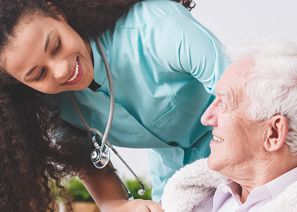 female nurse helping senior