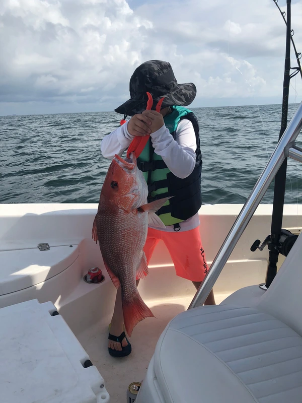Catching a red snapper on the ocean.