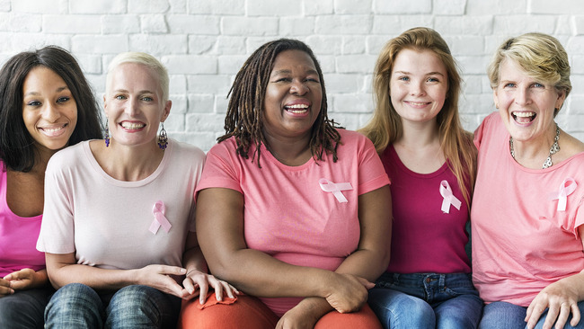 Women wearing breast cancer awareness ribbons