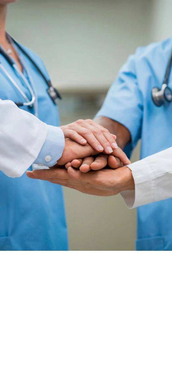 health care workers stack hands