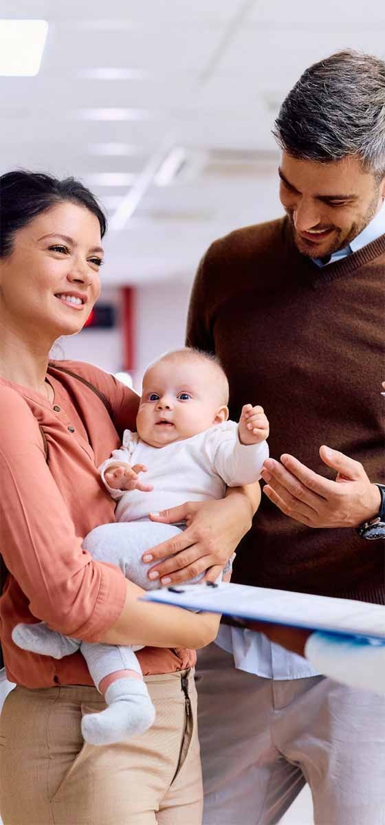 nurse talks to family with newborn