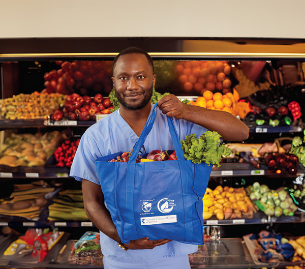 male nurse holding a food tote at NGH Food Pharmacy