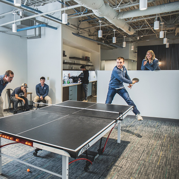employees playing ping pong