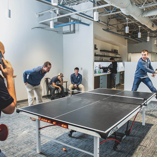 employees playing ping pong
