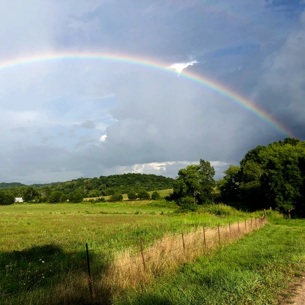 image of pastoral landscape and rainbow