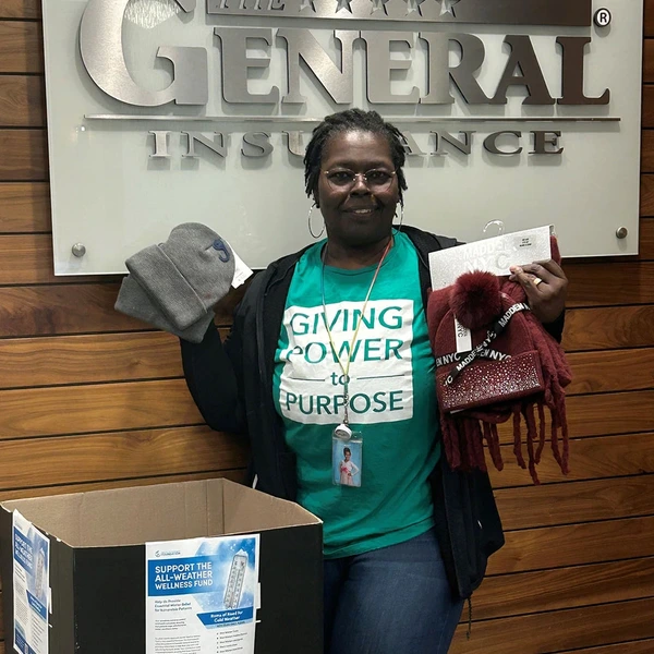 Customer Service Manager Angelique 'Angie' Walker delivers a generous donation to the All Weather Wellness Fund