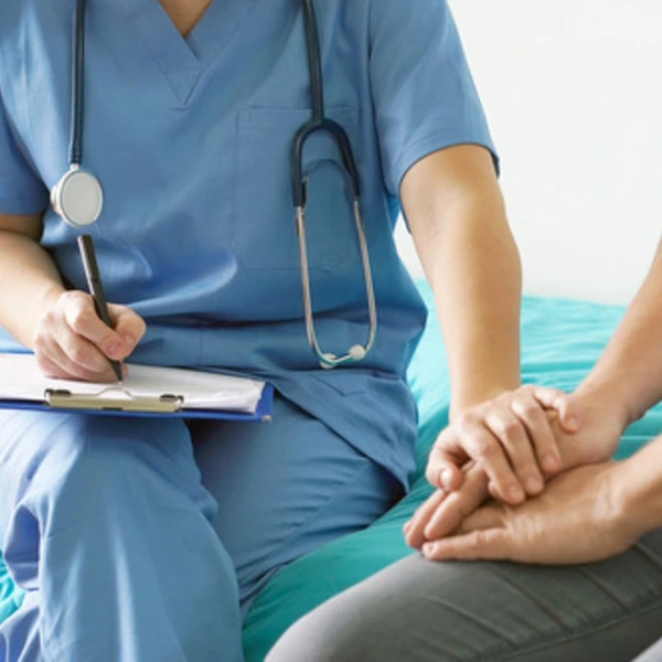 Nurse comforting a female patient