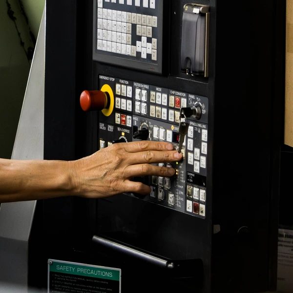 employee operating machine controls