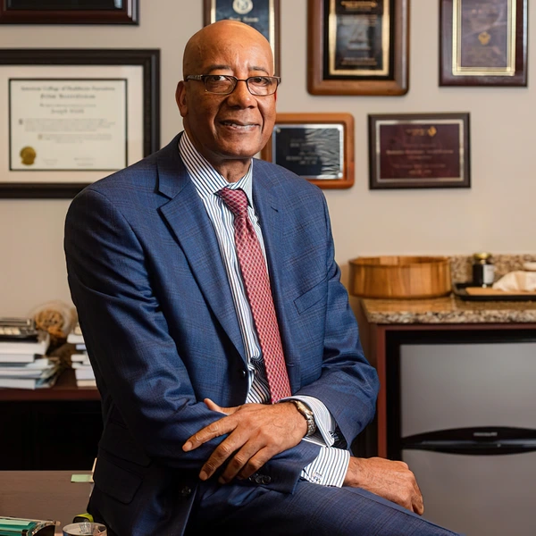 Dr. Webb posing at his desk