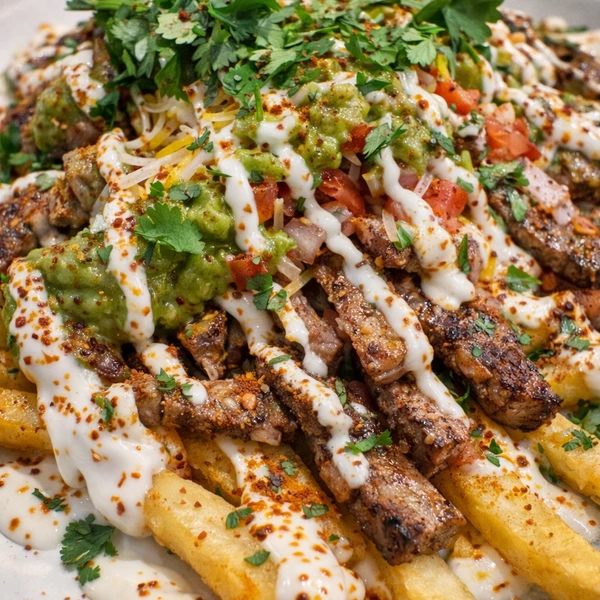 Image of fries loaded with steak and guacamole