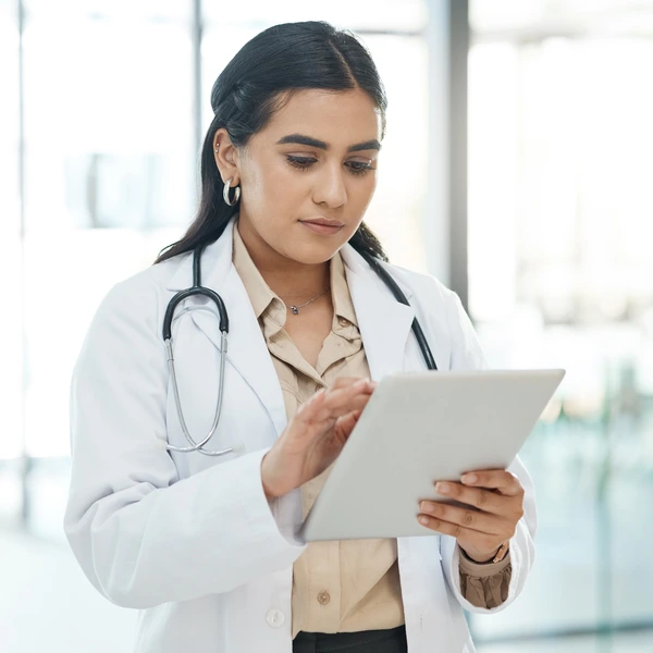 Physician reviewing patient data on a tablet
